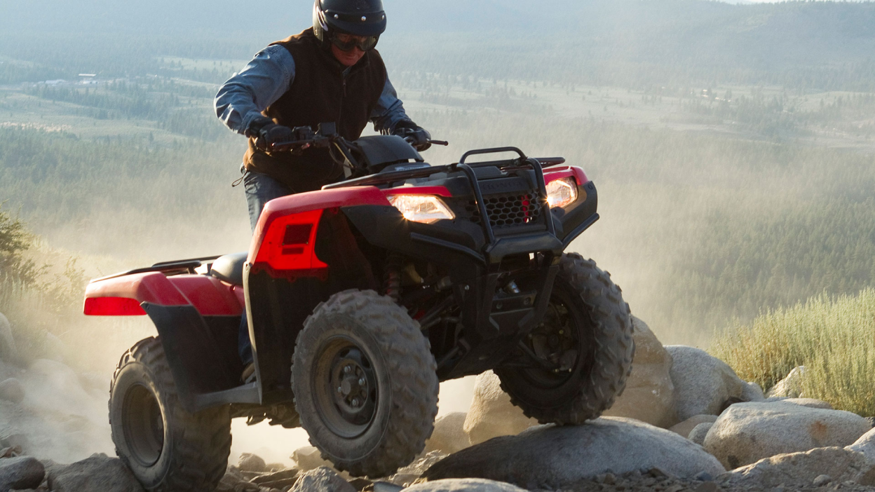 A rider going over a rock on a Rancher