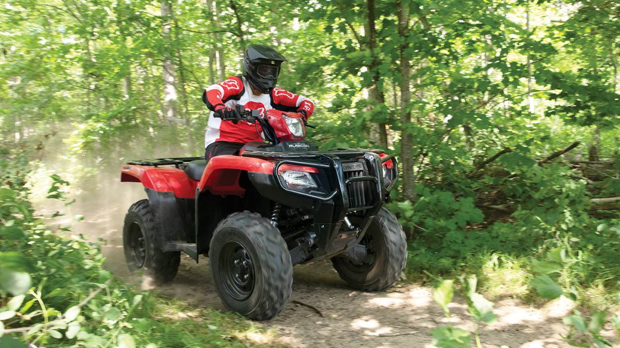 A rider on a trail on a Honda Rubicon