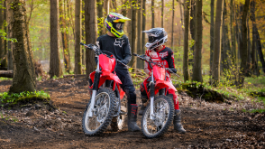 Two riders parked with their Honda CRFs