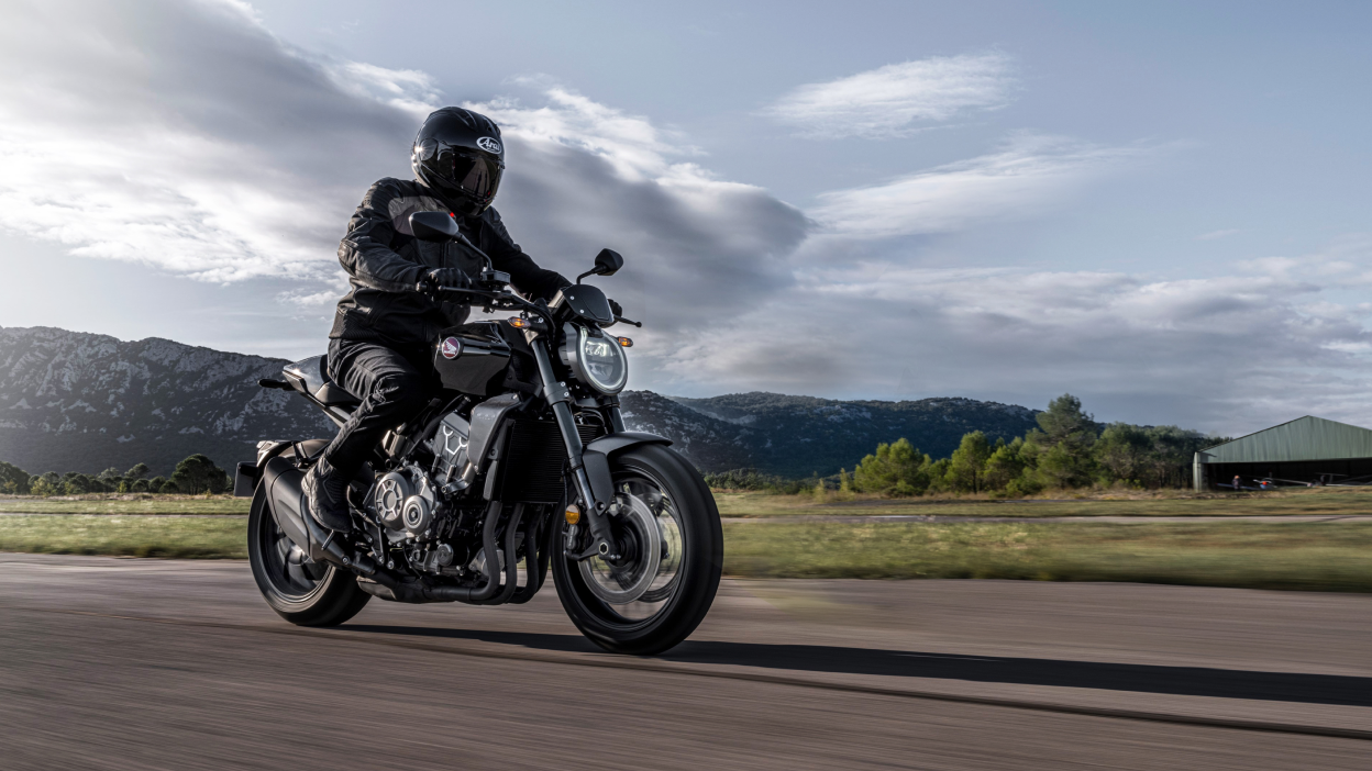 A rider on a Honda motrcycle on a sunny day